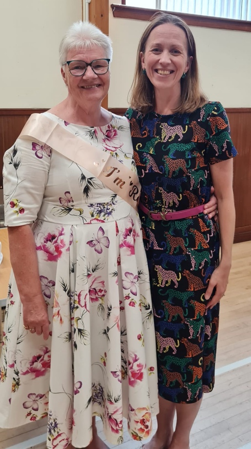 Miss Aitchison and Miss Sarah standing side-by-side, smiling for the camera