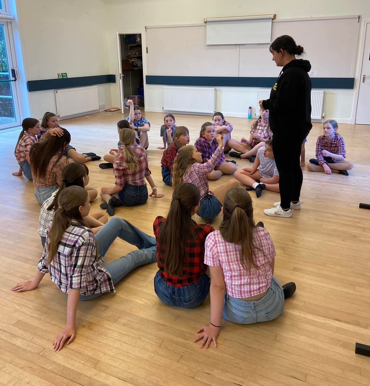 Miss Allyson teaching a group of students dressing in costumes